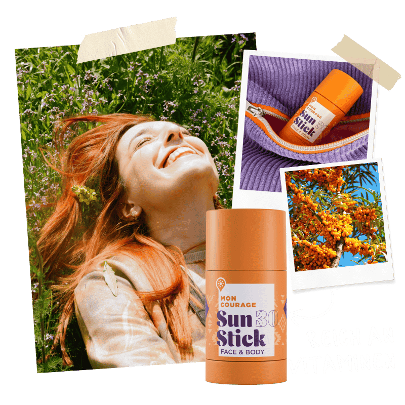 Frau liegt im Gras und genießt die Sonne dank Sun Stick